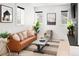 Comfortable living room with a leather sofa, stylish decor, modern fireplace, and a cozy armchair at 2515 Zenobia St, Denver, CO 80212