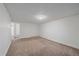 Spacious carpeted basement with neutral walls and ample light at 3730 Miller Ct, Wheat Ridge, CO 80033