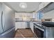 Modern kitchen with stainless steel appliances and white cabinets at 3730 Miller Ct, Wheat Ridge, CO 80033