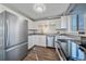 Modern kitchen features stainless steel appliances and stylish gray countertops at 3730 Miller Ct, Wheat Ridge, CO 80033