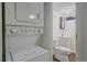 Basement laundry room with stackable washer and dryer, and toilet at 3730 Miller Ct, Wheat Ridge, CO 80033