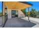 Large covered balcony with grey tile and iron railing overlooks the surrounding trees at 300 S Franklin St, Denver, CO 80209