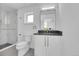 Modern bathroom featuring a glass enclosed shower, dark countertops, and sleek gold hardware at 300 S Franklin St, Denver, CO 80209