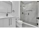 Modern bathroom featuring a glass shower with tile surround, sleek vanity, and matte black fixtures at 300 S Franklin St, Denver, CO 80209