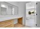 Modern bathroom vanity with drawers and white countertop, leading to a luxurious soaking tub at 300 S Franklin St, Denver, CO 80209