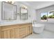 A luxurious bathroom is equipped with double sinks, a soaking tub, and brass fixtures at 300 S Franklin St, Denver, CO 80209