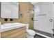 Modern bathroom with wood accent wall, glass-enclosed shower, and sleek fixtures at 300 S Franklin St, Denver, CO 80209