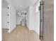 Bright entryway features light hardwood floors, white walls and ceilings, and a sleek open staircase at 300 S Franklin St, Denver, CO 80209