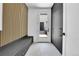 Modern entryway with wood accents, bench seating, and black storage cabinets at 300 S Franklin St, Denver, CO 80209