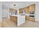 Open kitchen with a waterfall island, stainless steel appliances, and light wood cabinetry at 300 S Franklin St, Denver, CO 80209