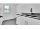 Laundry room with modern cabinets, sink, and dark tile flooring at 300 S Franklin St, Denver, CO 80209