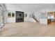 Open-concept living room with a modern fireplace, staircase, and seamless flow into the kitchen area at 300 S Franklin St, Denver, CO 80209