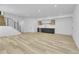 Spacious living room featuring light wood floors and a modern wet bar with custom cabinetry at 300 S Franklin St, Denver, CO 80209