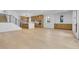 Open-concept living area with wood floors, stairs, and a modern kitchen with stainless steel appliances at 300 S Franklin St, Denver, CO 80209