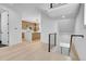 View of the kitchen and stairs with light hardwood floors, open design, and modern finishes at 300 S Franklin St, Denver, CO 80209