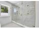 The bathroom features a spacious glass-enclosed shower with rainfall showerhead and elegant marble tiling at 300 S Franklin St, Denver, CO 80209