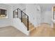 Modern staircase with black metal railings and light wood steps leading to the upper level at 300 S Franklin St, Denver, CO 80209
