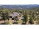 Breathtaking aerial view of a home surrounded by trees, offering serene privacy and a connection with nature at 8453 S Scenic Dr, Morrison, CO 80465