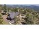 Expansive aerial shot of a home with a deck and mountain views, perfect for outdoor entertaining and relaxation at 8453 S Scenic Dr, Morrison, CO 80465