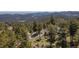 Nestled amidst trees, enjoy this home with views of the mountains at 8453 S Scenic Dr, Morrison, CO 80465