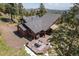 Picture of the back of a home with a spacious deck and outdoor dining area, ideal for enjoying the mountain scenery at 8453 S Scenic Dr, Morrison, CO 80465