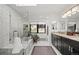 Bright bathroom with soaking tub, dual vanity, and walk-in shower at 8453 S Scenic Dr, Morrison, CO 80465