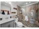 Modern bathroom featuring a glass-enclosed shower with stone tile, a vessel sink, and wooden accents at 8453 S Scenic Dr, Morrison, CO 80465