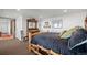Bedroom with a rustic wooden bed frame, antique dresser, and elegant decor, offering a cozy retreat at 8453 S Scenic Dr, Morrison, CO 80465