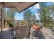 Inviting deck with comfortable seating, an umbrella, and breathtaking views of the surrounding landscape at 8453 S Scenic Dr, Morrison, CO 80465