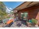 Spacious deck featuring comfortable lounge areas, an awning, and stunning views of nature, ideal for relaxation at 8453 S Scenic Dr, Morrison, CO 80465