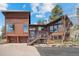 Exterior of a wood home with large windows, a front porch, and meticulous landscaping at 8453 S Scenic Dr, Morrison, CO 80465
