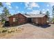 Charming home with wood exterior and beautiful landscaping and stone pathway at 8453 S Scenic Dr, Morrison, CO 80465