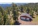 Spacious two-car garage, perfect for storage and parking with beautiful trees on the property at 8453 S Scenic Dr, Morrison, CO 80465