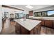Bright, open kitchen features granite counters and large island with views into the living room at 8453 S Scenic Dr, Morrison, CO 80465