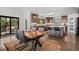 Spacious kitchen features wood cabinets, island with seating, and access to outdoor deck at 8453 S Scenic Dr, Morrison, CO 80465