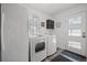 Functional laundry room with new washer and dryer, ample natural light, and sleek cabinetry at 8453 S Scenic Dr, Morrison, CO 80465