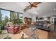Open-concept living room with expansive windows showcasing mountain views, adjacent to kitchen at 8453 S Scenic Dr, Morrison, CO 80465