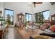 Bright living room boasts floor-to-ceiling windows with breathtaking mountain views and hardwood floors at 8453 S Scenic Dr, Morrison, CO 80465