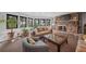Cozy living room with a stone fireplace, comfortable seating, and large windows offering picturesque views at 8453 S Scenic Dr, Morrison, CO 80465