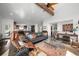 Spacious living room featuring vaulted ceiling with wood beam and mountain views at 8453 S Scenic Dr, Morrison, CO 80465