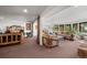 Open-concept living area with a rustic bed, two couches, and large windows showcasing scenic outdoor views at 8453 S Scenic Dr, Morrison, CO 80465