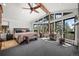 Spacious main bedroom features vaulted ceiling, wood beam, and multiple windows with forest views at 8453 S Scenic Dr, Morrison, CO 80465