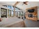 The main bedroom features a fireplace, wood beam, and gorgeous views at 8453 S Scenic Dr, Morrison, CO 80465