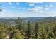 Breathtaking view from the property showcasing rolling hills and a blue sky at 8453 S Scenic Dr, Morrison, CO 80465