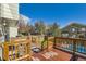 Back deck overlooking green grass and in-ground pool at 6464 S Swadley Way, Littleton, CO 80127