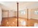 Spacious basement featuring hardwood floors, wooden pillars, and natural light at 6464 S Swadley Way, Littleton, CO 80127