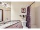 Cozy bathroom featuring a shower/tub combo with vanity and granite countertop at 6464 S Swadley Way, Littleton, CO 80127