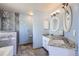 Stylish bathroom featuring double sinks with granite countertops and a walk-in shower at 6464 S Swadley Way, Littleton, CO 80127