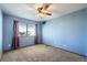 Comfortable bedroom featuring plush carpet, neutral walls, and a ceiling fan at 6464 S Swadley Way, Littleton, CO 80127