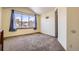 Bright bedroom with plush carpet, neutral walls, and large windows with natural light at 6464 S Swadley Way, Littleton, CO 80127